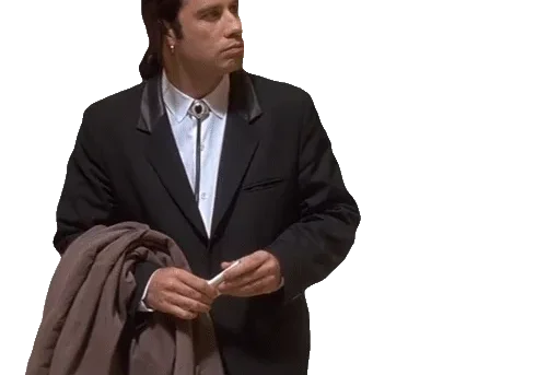 Man in suit holding coat, looking puzzled.